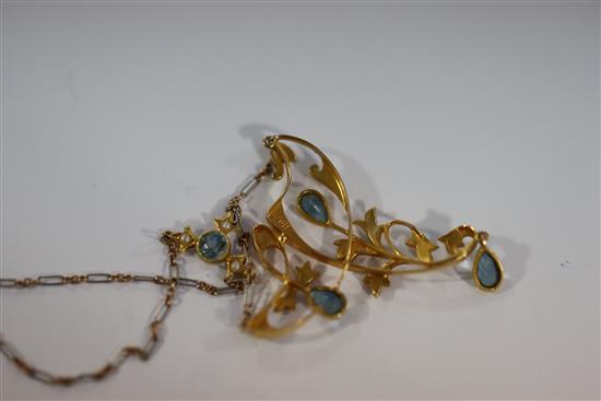 An Edwardian 15ct gold, aquamarine and seed pearl set foliate drop necklace with two colour gold chain,